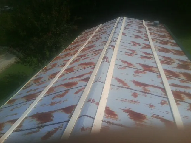 Rusted metal roof panels with new wood purlins before replacement — Storm Damage Roof Repair in Sebastian by Roofing Brothers